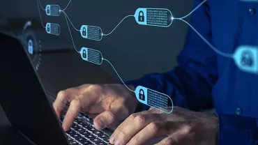 Person typing on a laptop with blockchain symbols and digital locks overlaid.
