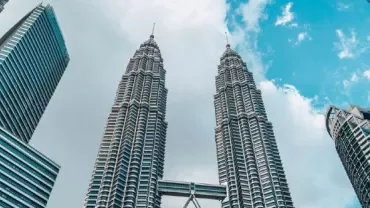 Skyscrapers against a blue sky with clouds.
