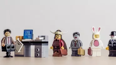 LEGO minifigures stand in line for an office job interview.