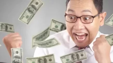 An excited man with money falling over him to represent having a highest paying job in his region.