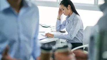 Focused woman in an office working at a desk.