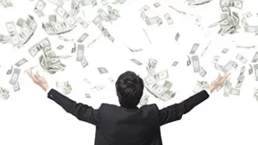 Man in suit with arms raised, surrounded by falling dollar bills.