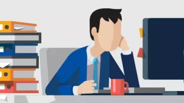 Illustration of a tired office worker at desk with computer and stack of folders.