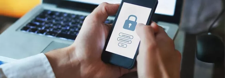Person holding smartphone with padlock login screen.