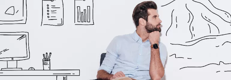 Man sitting in front of wall with doodles of office space and mountains.
