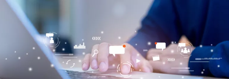 Person typing on a laptop with digital icons representing communication and technology.