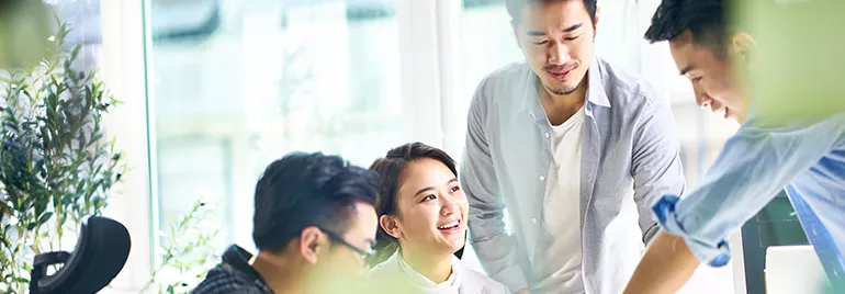 Group of people collaborating at a bright office.