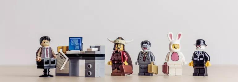 LEGO minifigures stand in line for an office job interview.
