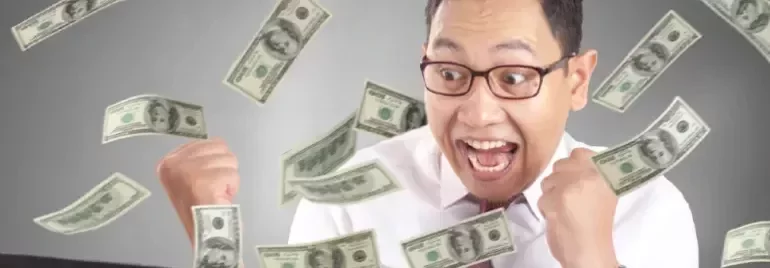 An excited man with money falling over him to represent having a highest paying job in his region.