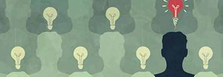 Silhouette with a red light bulb among many gray light bulbs, symbolizing unique ideas.