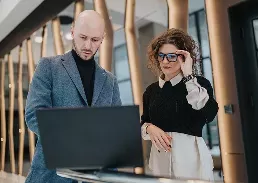 man and woman looking at a laptop