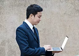 man holding a laptop