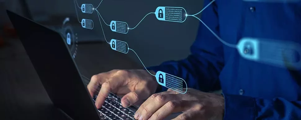 Person typing on a laptop with blockchain symbols and digital locks overlaid.