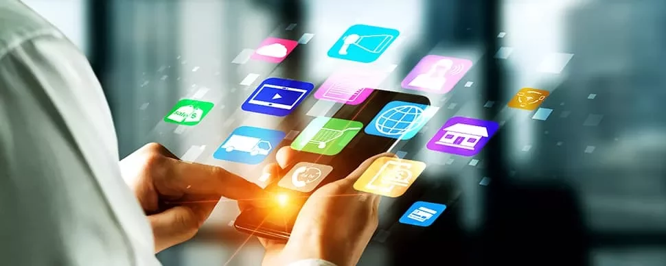 Person using a smartphone surrounded by colorful app icons.