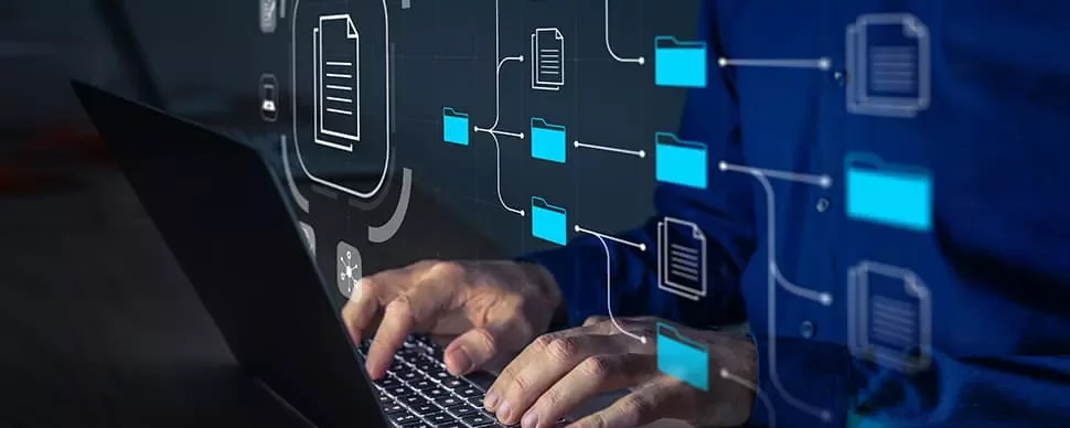 Person typing on a laptop with overlay of digital file and folder icons