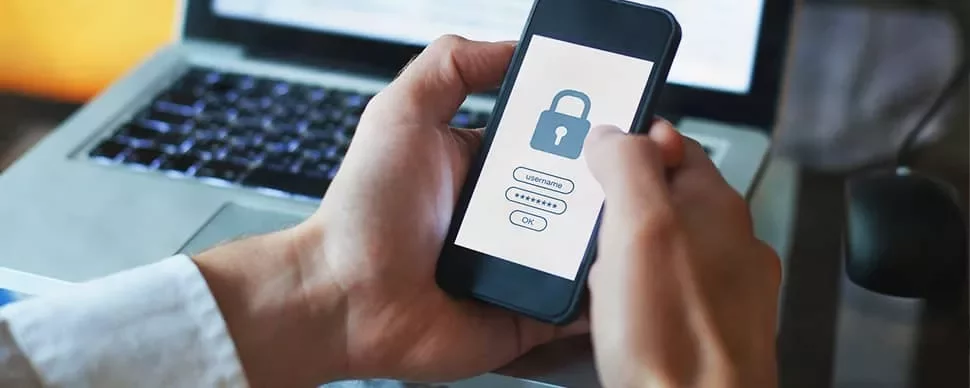 Person holding smartphone with padlock login screen.