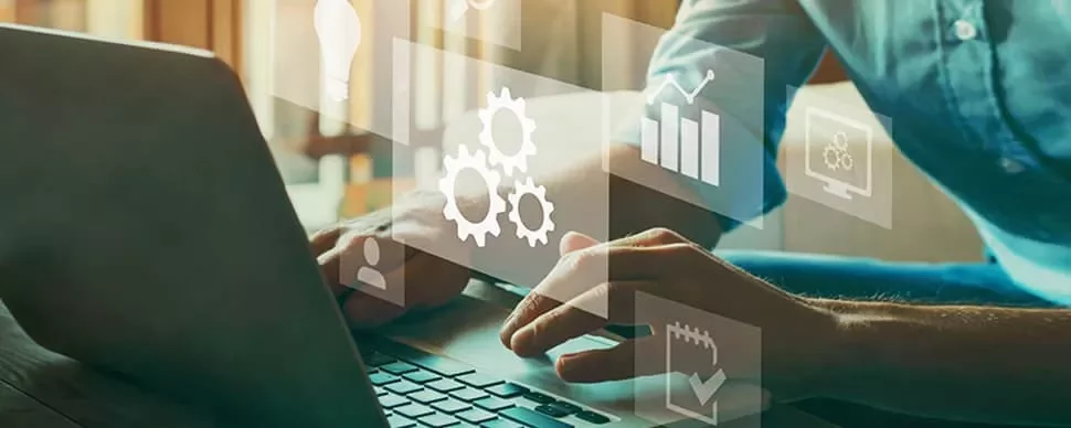 Person typing on laptop with digital technology icons overlaid.