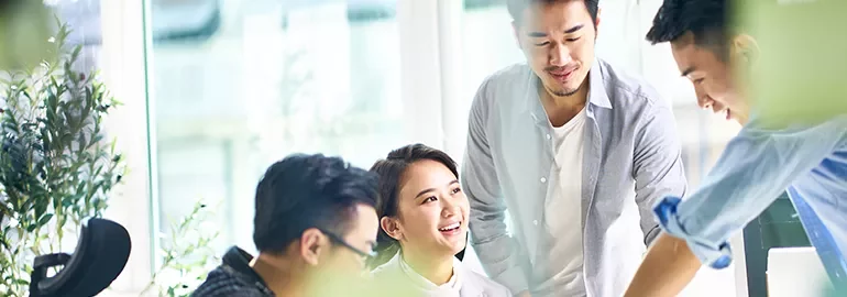 Group of people collaborating at a bright office.