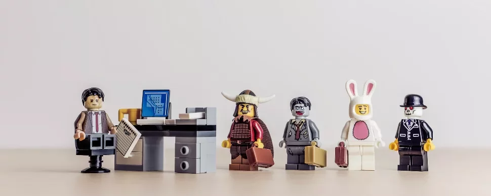 LEGO minifigures stand in line for an office job interview.