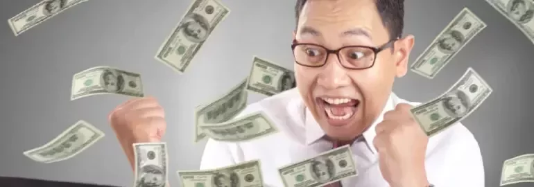 An excited man with money falling over him to represent having a highest paying job in his region.