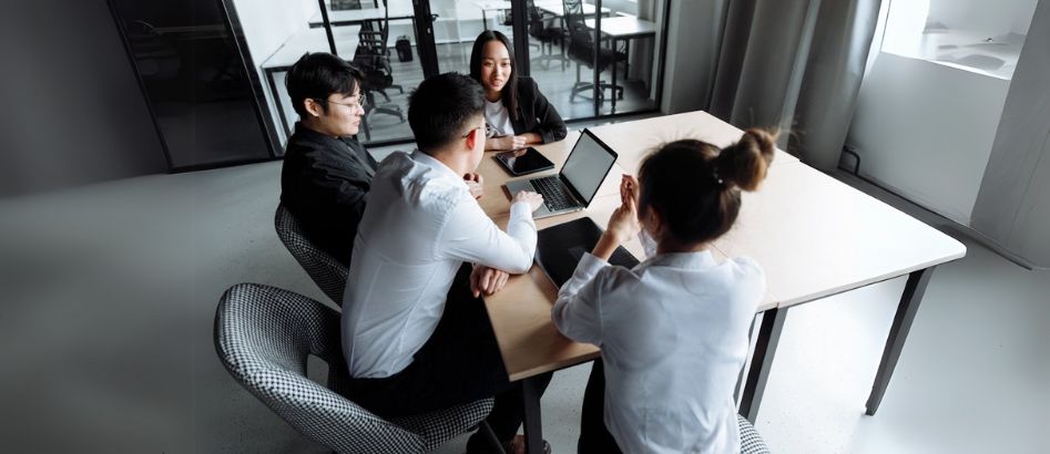 A group of professionals discussing the selection of their partnership with Taiwan's top recruitment agencies